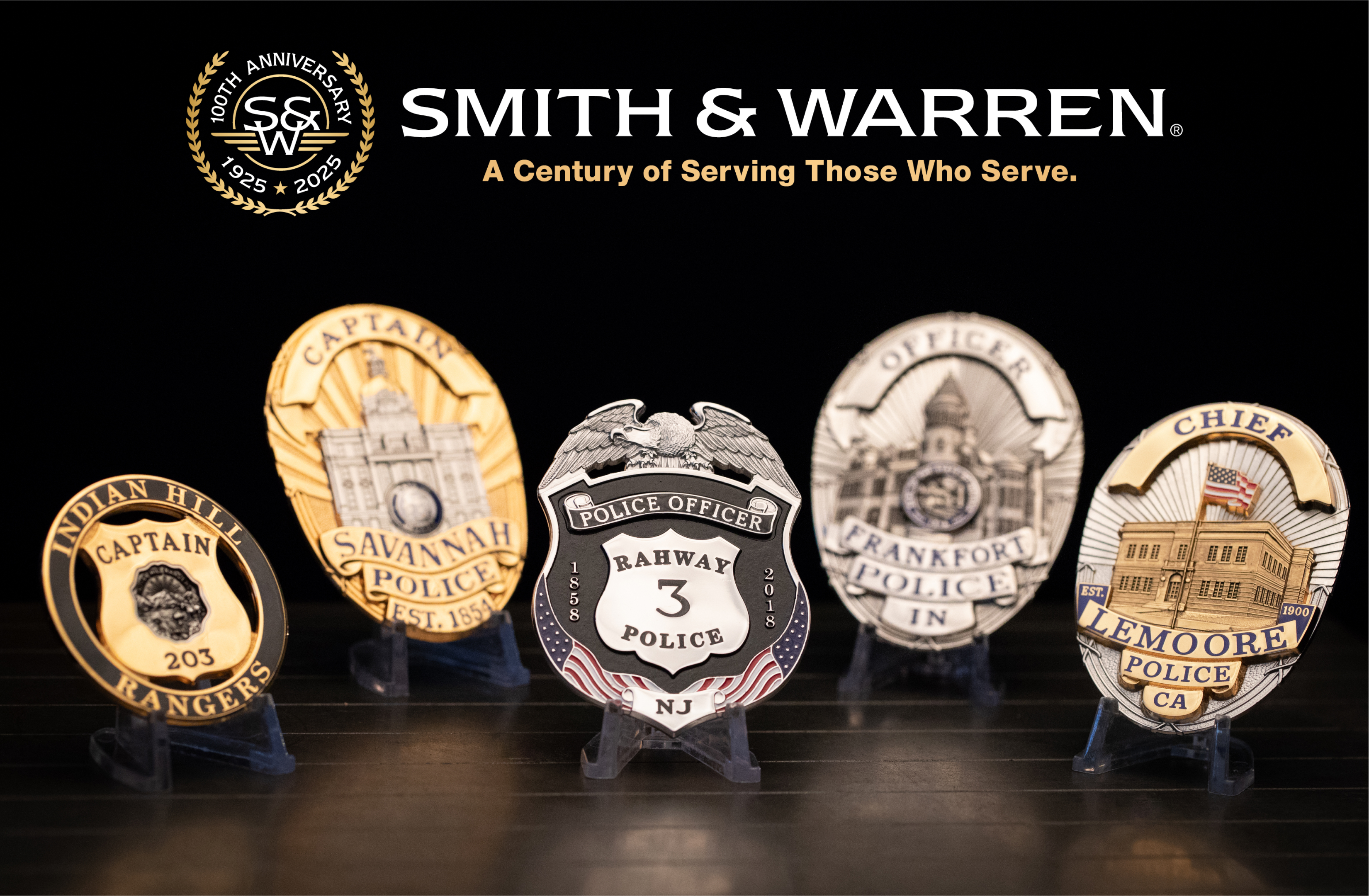 Five smith and warren badges displayed on metal sheet