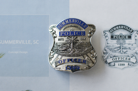 Custom metal police badge for Summerville South Carolina next to the concept drawing.